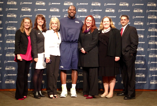 Kim and staff with Okung