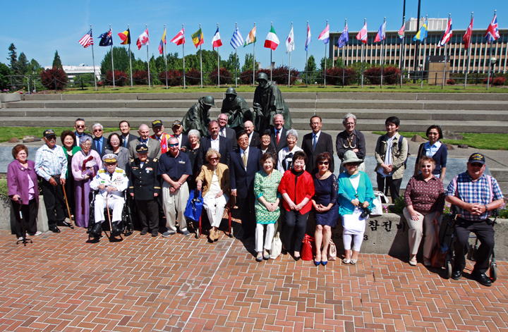 Korean War veterans and people with ties to Korea meet in front of Korean War Memorial.