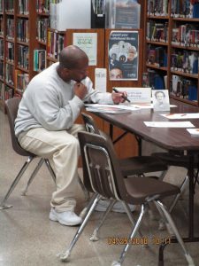 An inmate works on poetry