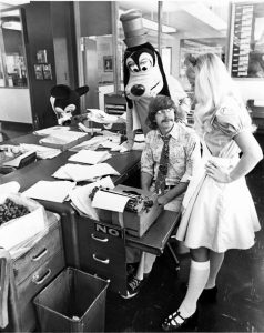 Tom Robbins with Disney characters in newsroom