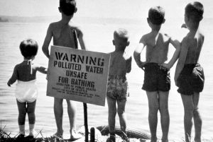 By the late 1950s parts of Lake Washington were unsafe for swimming. This photo from 1958 was part of the campaign to create the Municipality of Metropolitan Seattle (“Metro”) to oversee sewage treatment. Metro photo 