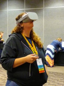 A Washington Library Association conferencegoer looks through virtual reality goggles