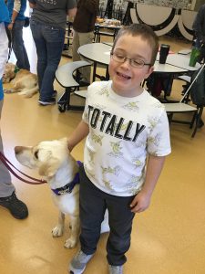 Student greeting a support dog