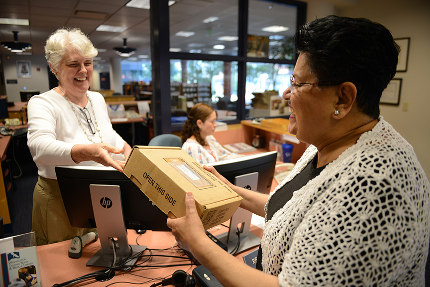 A WTBBL patron receives her new digital talking book player.