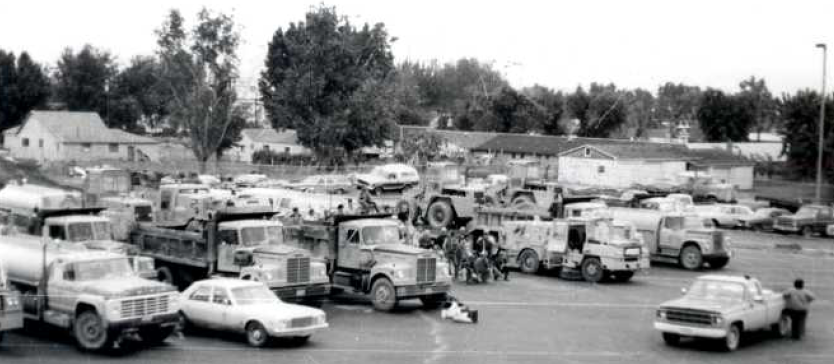 Black and white photo of a parking lot in Yakima full of clean up vehicles.