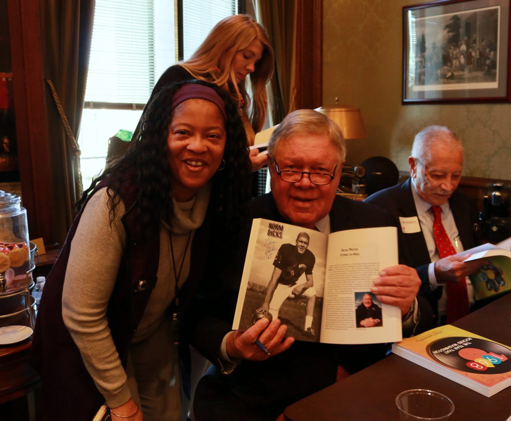 Legacy Washington celebrated the 2019 release of “1968: The Year That Rocked Washington” with a book-signing featuring several of the remarkable Washingtonians who were profiled in the book. Above, former U.S. Rep. Norm Dicks and a guest pose with his page and autograph (Photo: Legacy Washington).