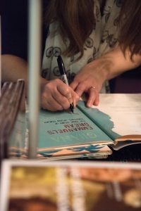 Picture of a woman signing books