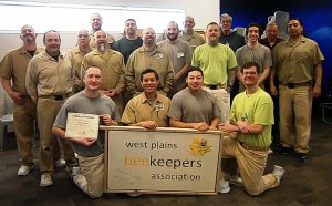 Picture of a group of men with a Banner that says West Plains Beekeepers Association